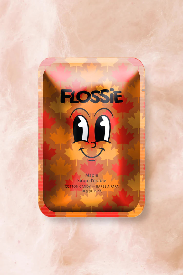 bronze metallic rectangular packaging with a maple leaf background, the text flossie, and a cartoon smiling face