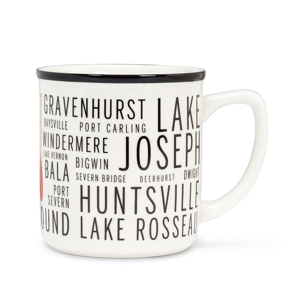white mug and with a black rim, with different sied text of different areas in cottage country