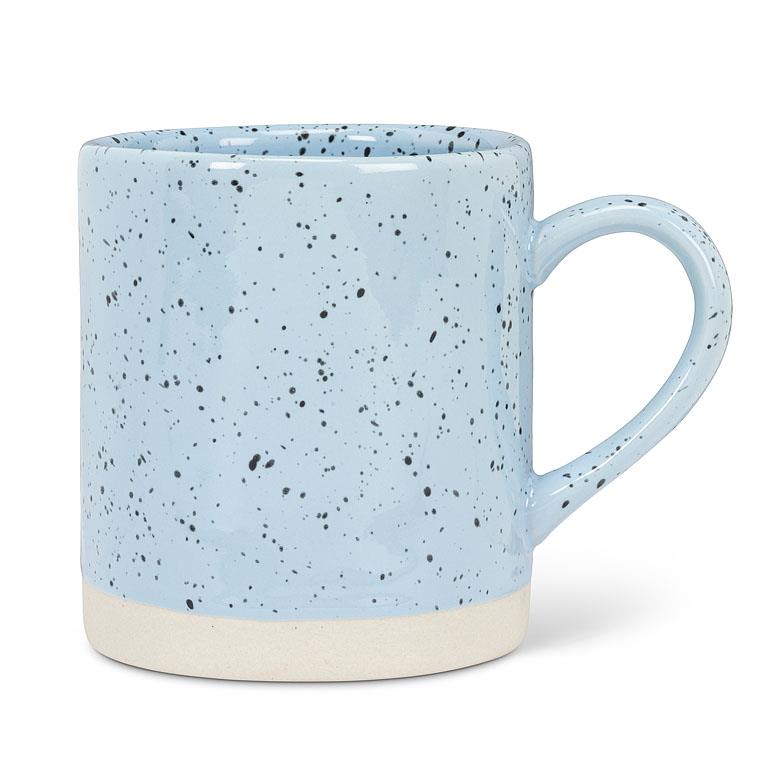 blue mug with a white base, and spots of black across the mug