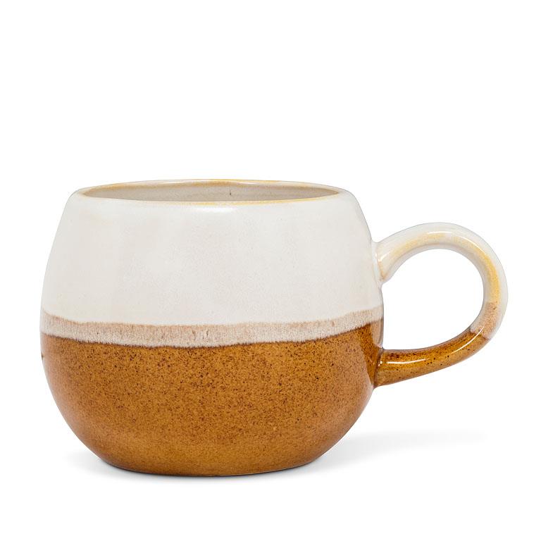 white and brown round textured mug
