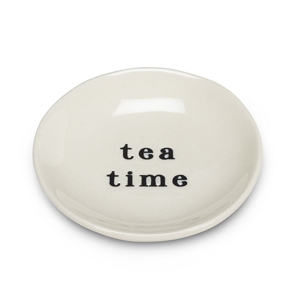 side angle of round white dish with black font that says tea time 