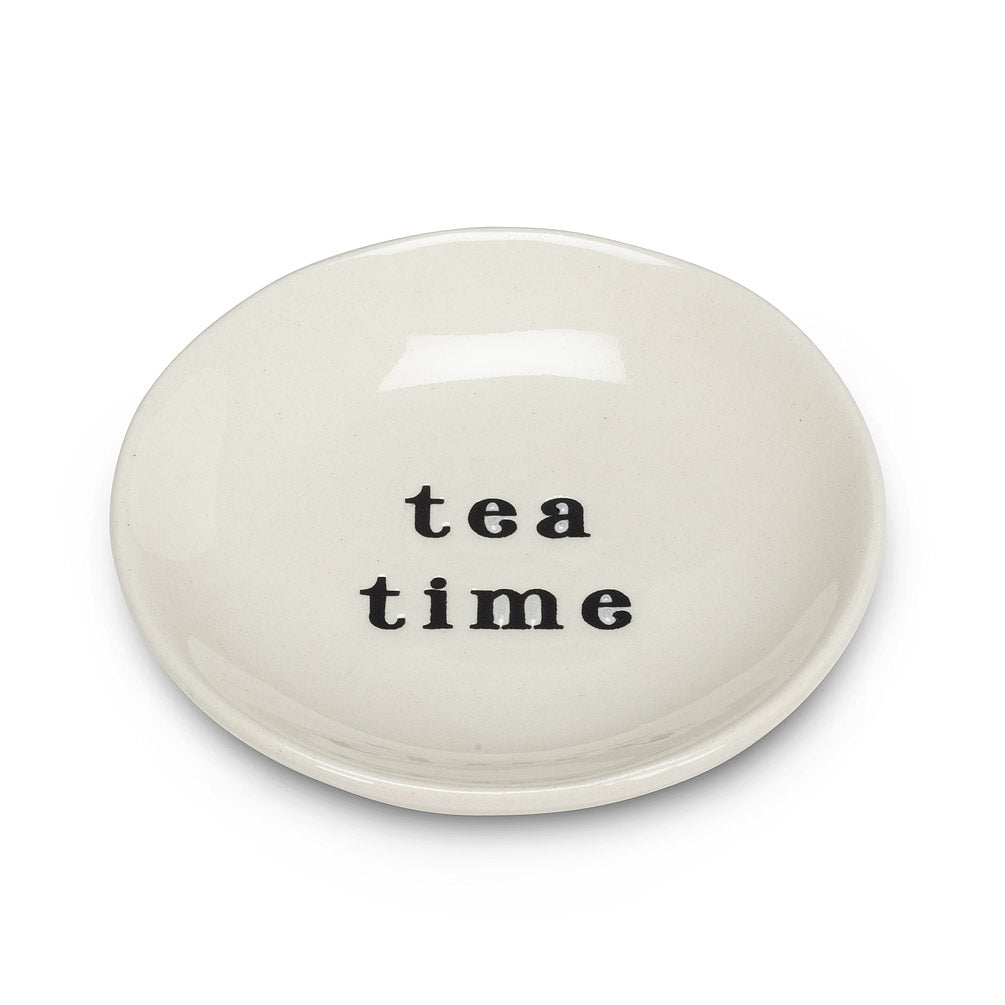 side angle of round white dish with black font that says tea time