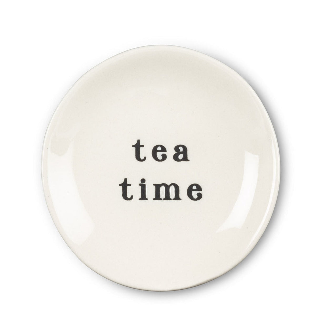 Round white plate with black font that says tea time 