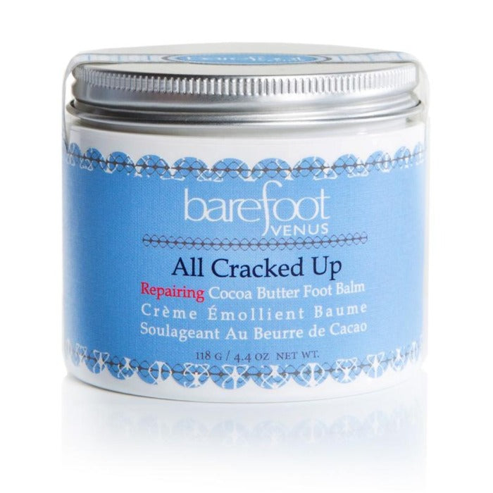 white fot cream jar with a silver lid, and a light blue intricate label