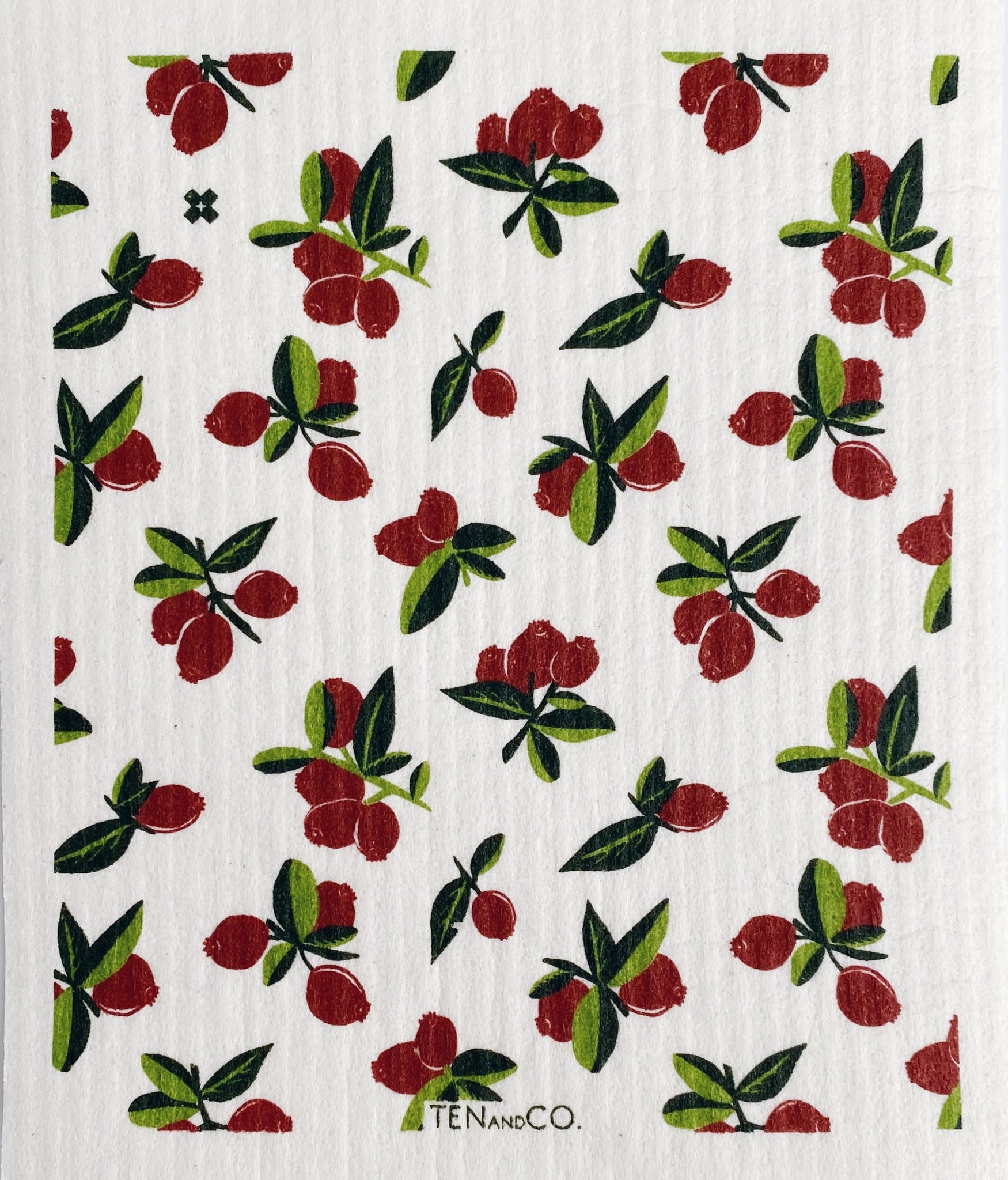 white dishcloth with red cranberries across the entire cloth