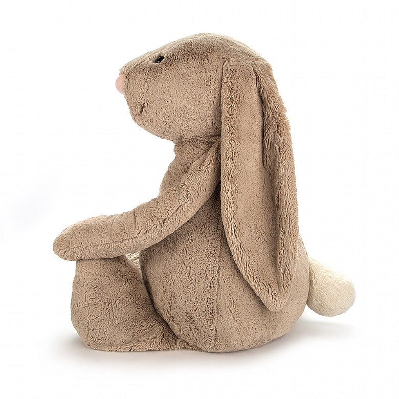 side view of a soft plush bunny smiling with floppy ears 