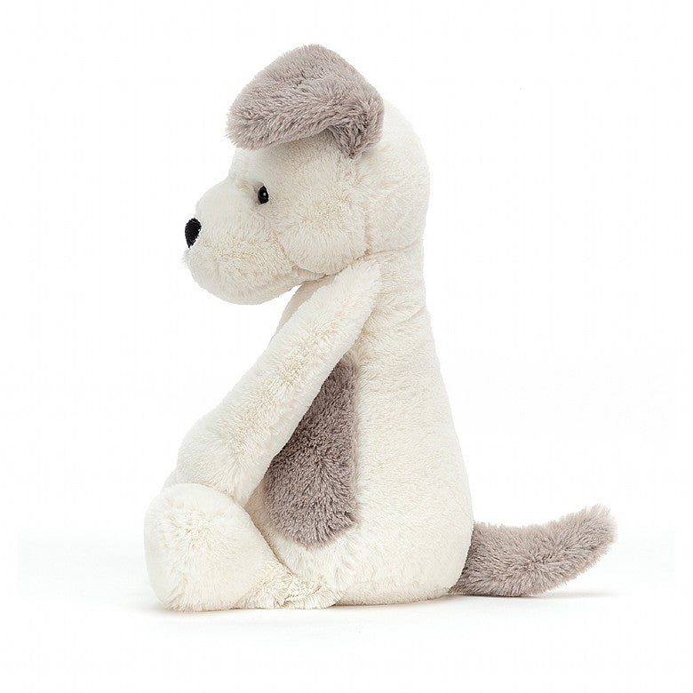 Side view of a plush light brown and white terrier