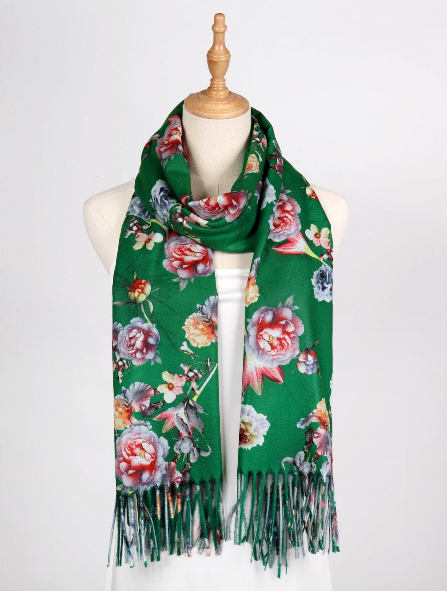 green scarf with tassels and multi-coloured flowers