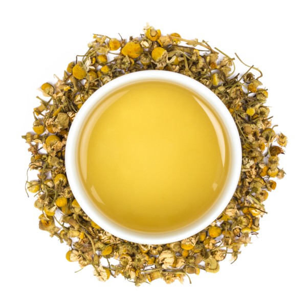 yellow tea in a white mug surrounded by light brown tea leaves