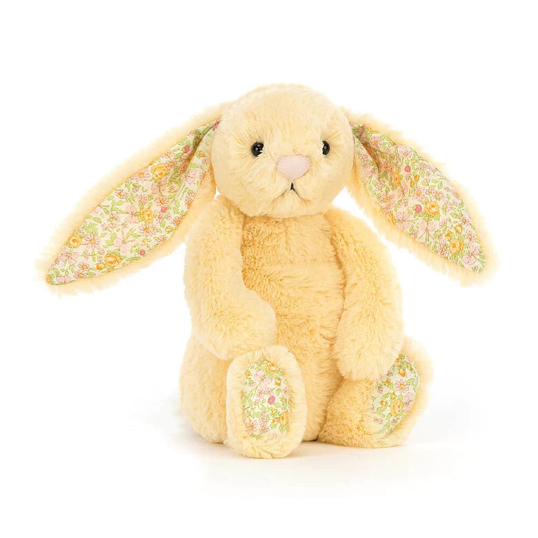 Light yellow plush bunny with a yellow floral design on the bottom of the feet and the inner ears  