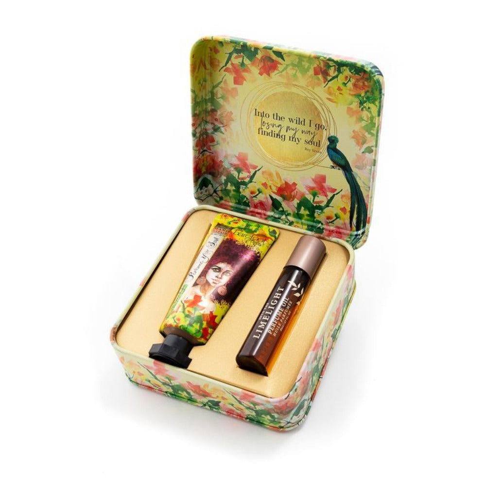 yellow and red floral open square tin with a lotion package and red glass oil cylinder  