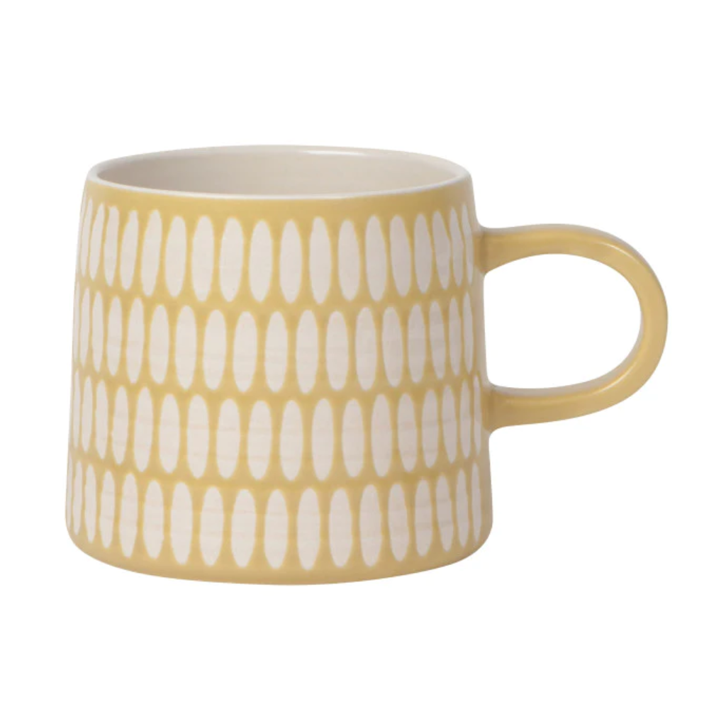 light yellow mug with a white oval pattern across the entire mug