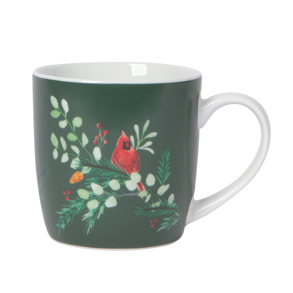 Bluish-green mug with a white handle, and an evergreen branch with a red cardinal perched on the branch