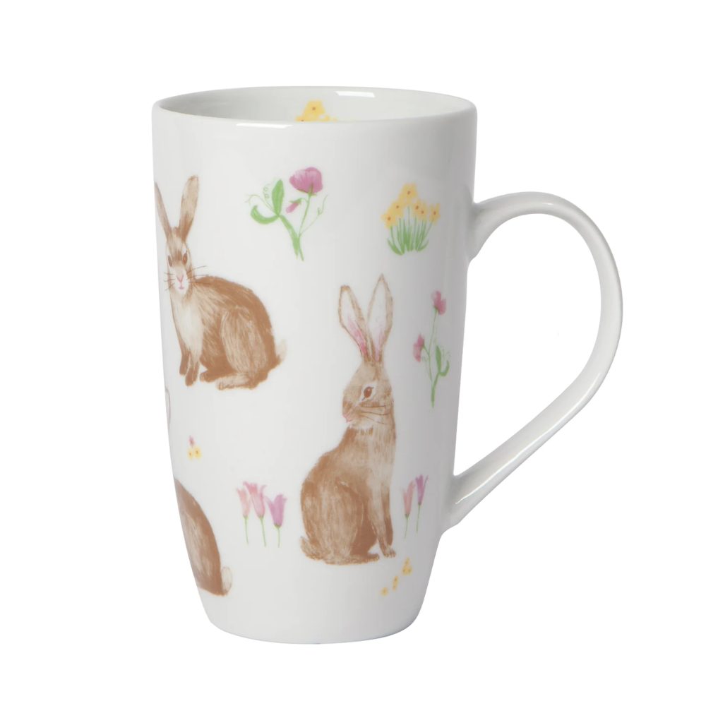 tall white mug with different watercolour bunnies and different coloured flowers printed on the mug