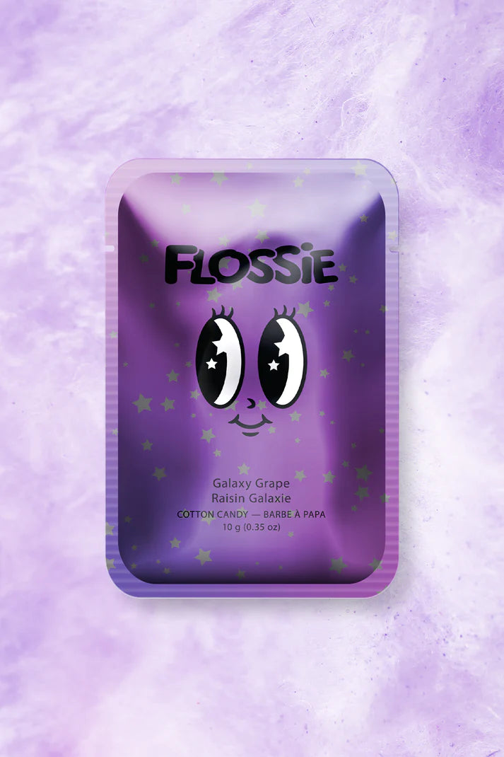 Purple metallic rectangular package with a cartoon smiling face, and stars in the background