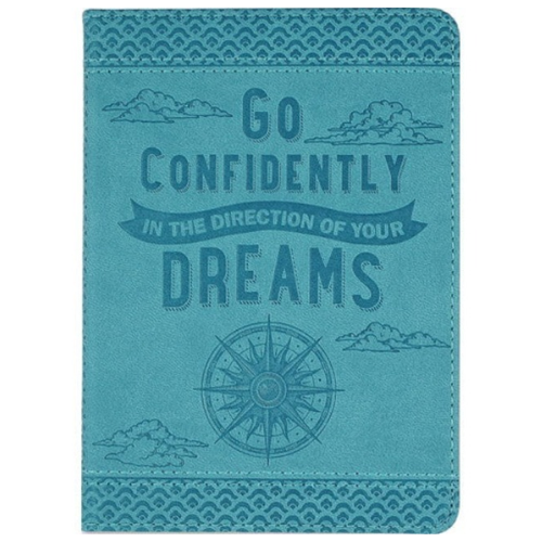 Light blue journal with dark blue intricate designs at the top and bottom, clouds, text that reads" go confidently in the direction of your dreams", and a compass below it.