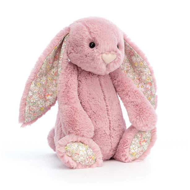 light pink plush bunny with a green floral design on the inner ears and bottom of the feet