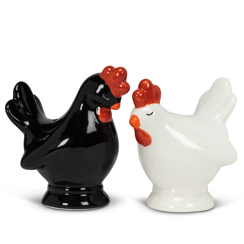 salt and pepper shakers in the shape of chickens, with one white and one black