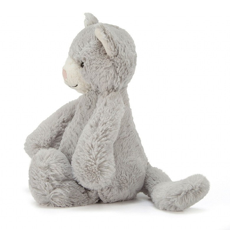 side view of a light grey plush cat with white ears and nose 