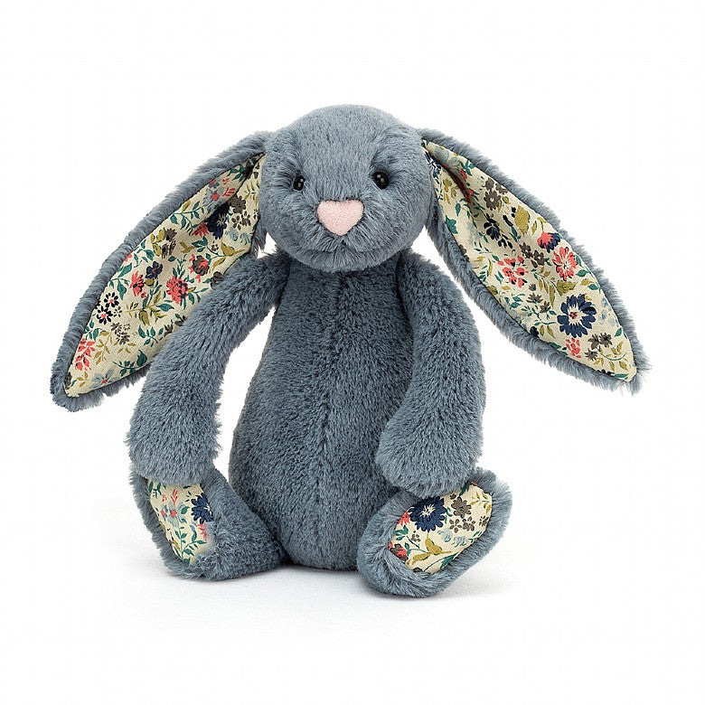 Bluish grey bunny with an multicoloured flower pattern on the bottom of the feet and the inner ears