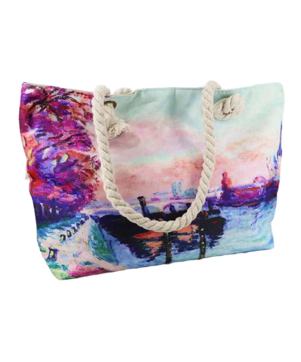 Tote bag with white handles and an oil painting print of a lakeside in a blue pallette