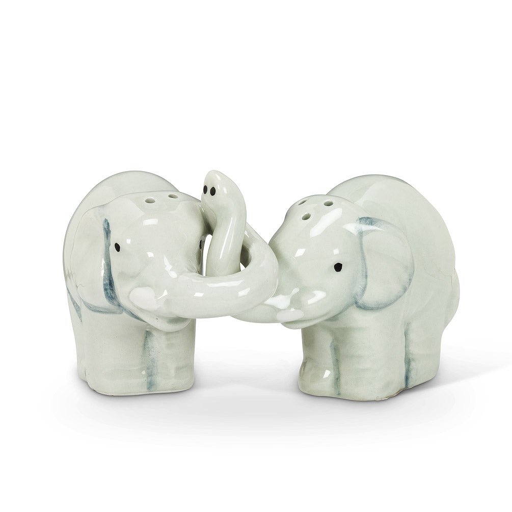 salt and pepper shakers in the shape of white elephants intertwined by their trunks