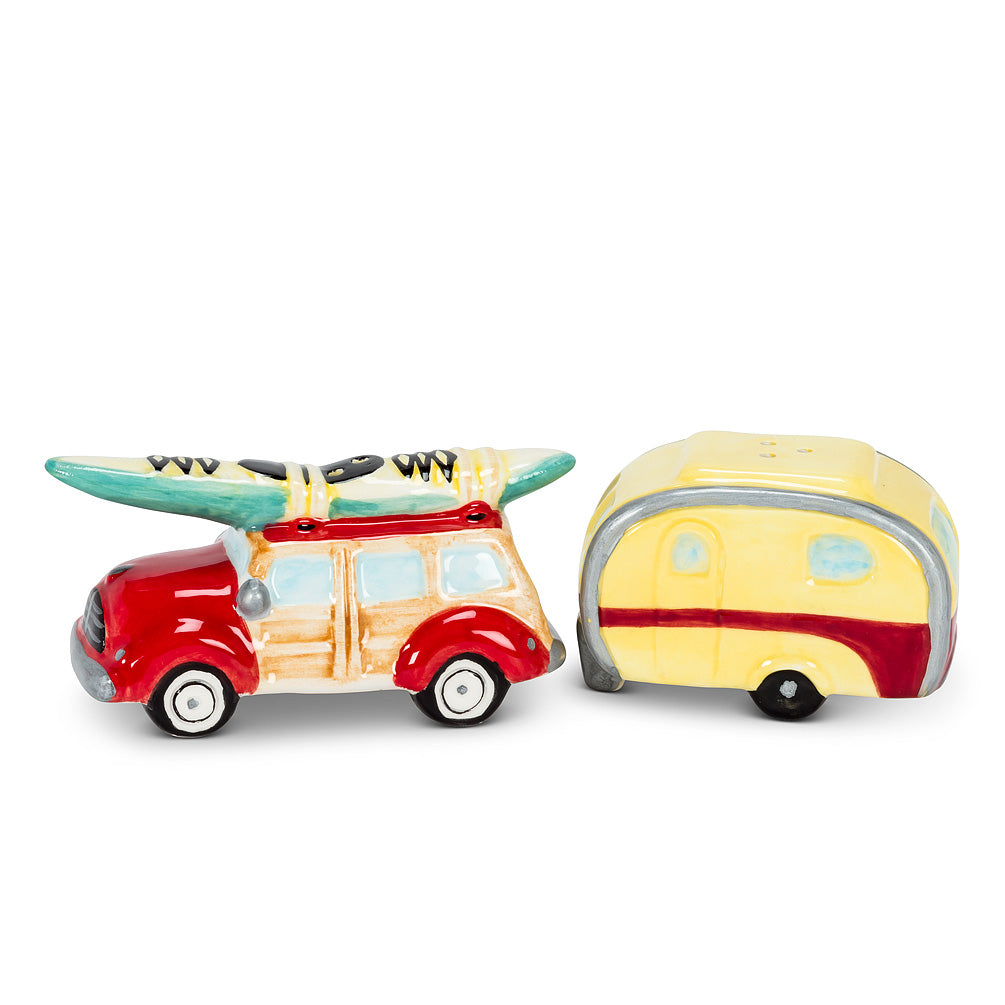 Two salt and pepper shakers in the shape of a vintage wood panel station wagon with a kayak, and a red and yellow vintage camper