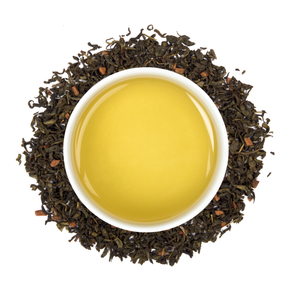 Yellow tea in a white mug surrounded by brown tea leaves