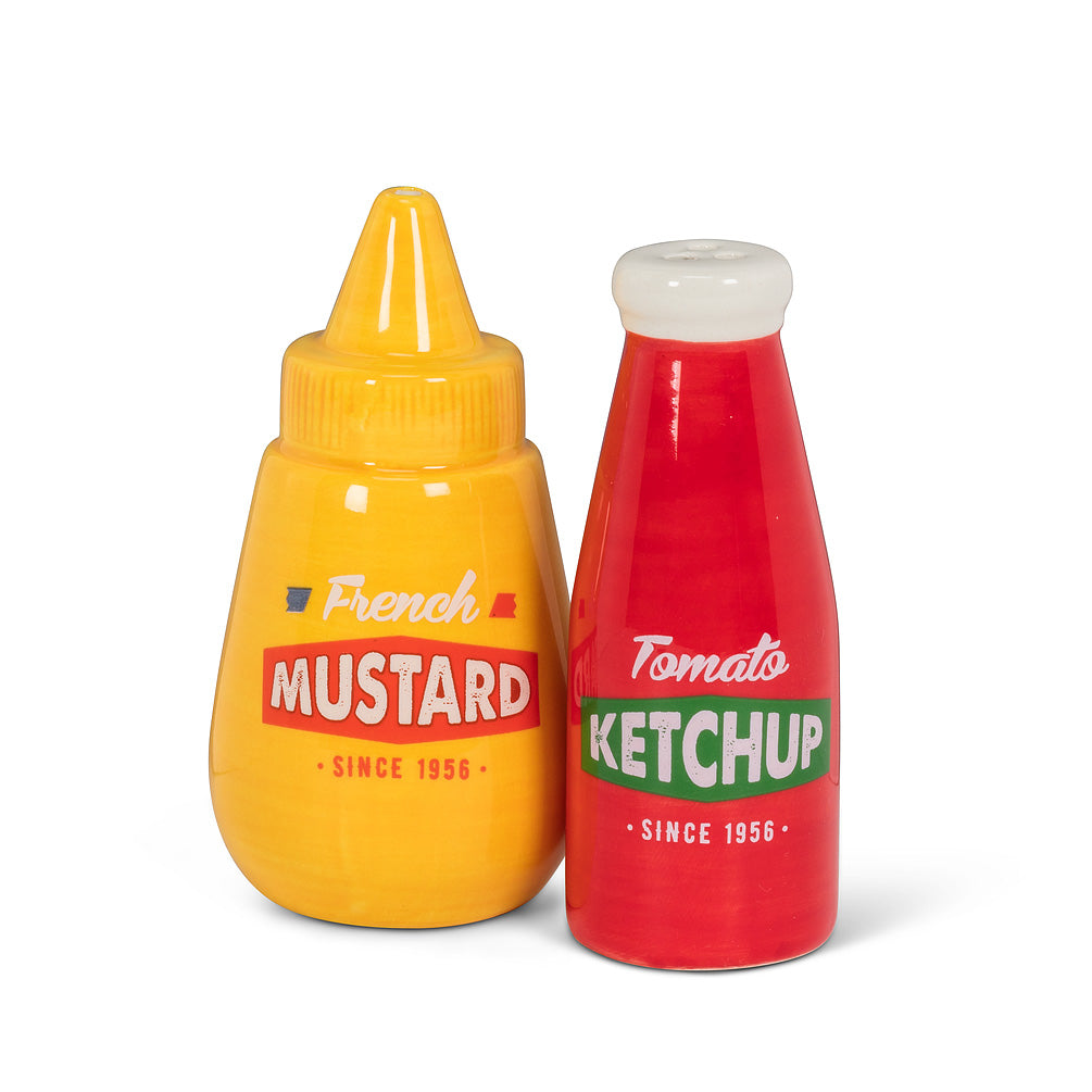 two salt and pepper shakers, one in the shape of a yellow mustard bottle, and the other in the shape of a red vintage ketchup bottle