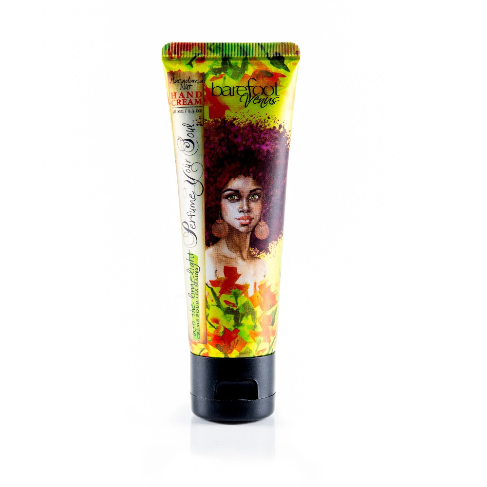 oil cream hand tube with a light green, yellw, and red floral design and a woman with an afro in the middle
