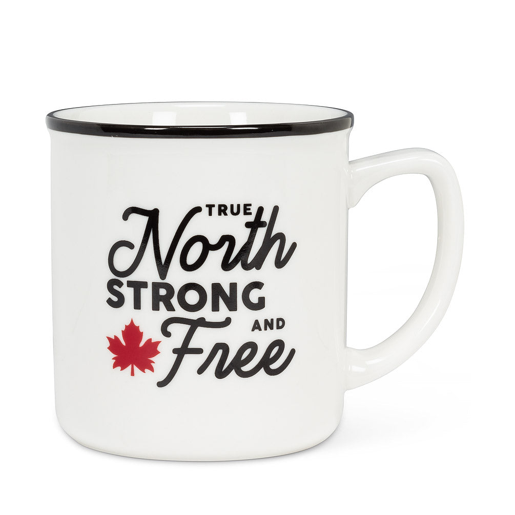 white mug with black rim, and text that says "true north strong and free" with a red maple leaf beside it 
