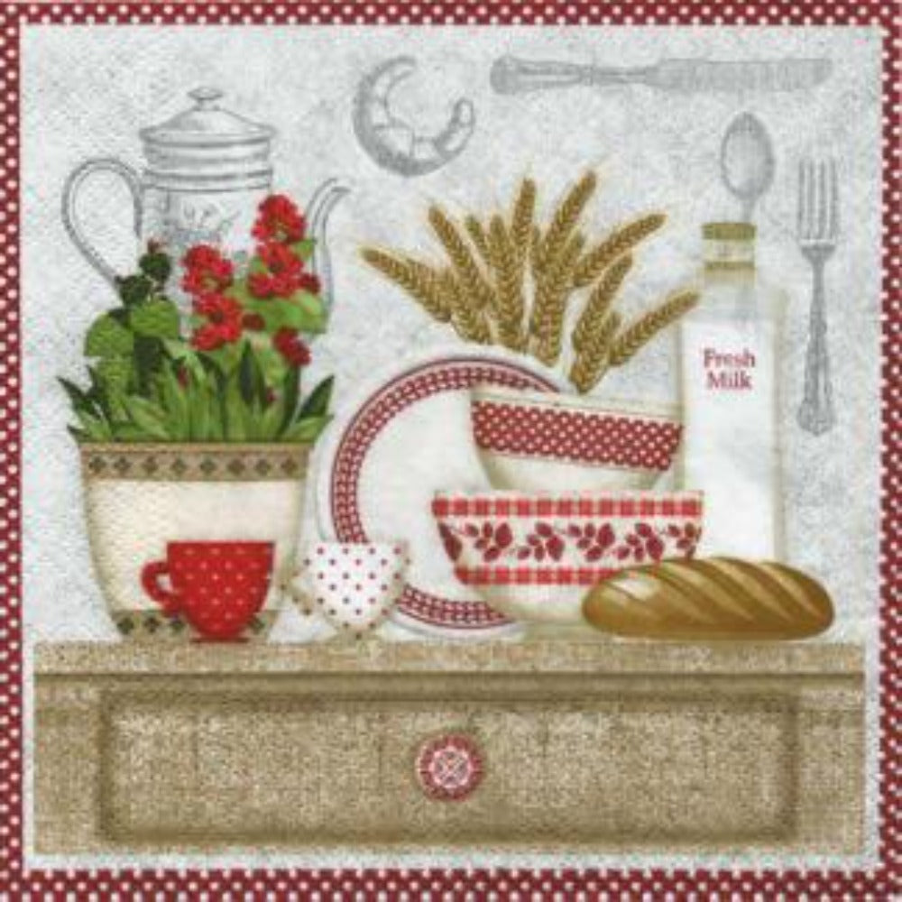 white napkin with red and white border, and a drawing of a country style kitchen that has various dishes, fruits, bread, and milk