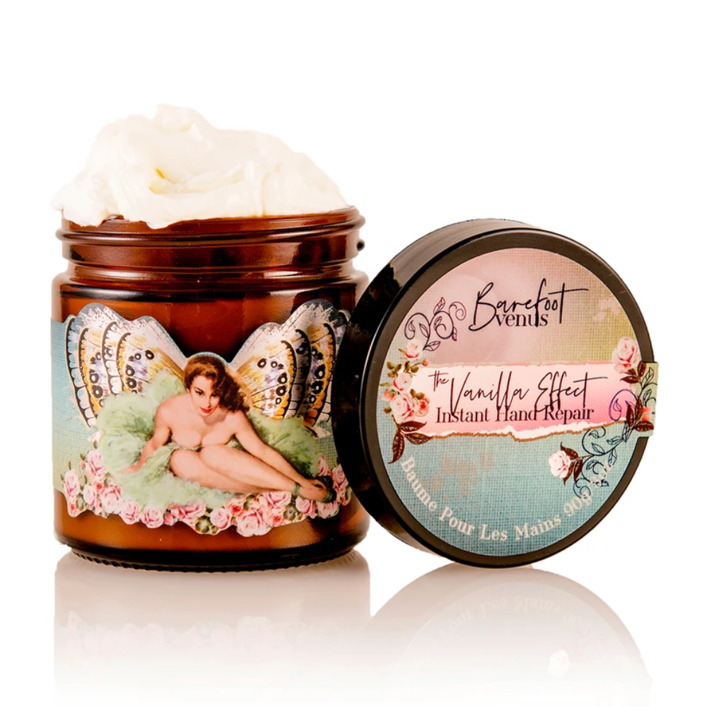 hand cream jar with a light blue, light green, and light pink label with a pin up model sitting on a light green flower with butterfly wings behind her 